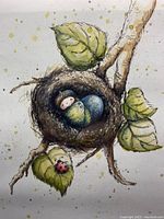 Close-up of the framed print showing a tiny baby with acorn hat resting in a nest surrounded by leaves and a ladybug.