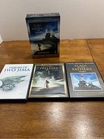 Set of three DVDs (Heroes of Iwo Jima, Letters From Iwo Jima, Flags of Our Fathers) in cases and a box sleeve shown from front.