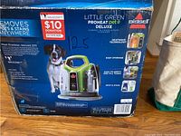 Box front and details for Bissell Little Green ProHeat Pet Deluxe cleaner showing product features and donation sticker