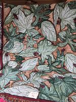 Full view of throw blanket showing leaves and ladybugs design and texture.