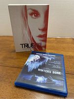 Photo showing the True Blood Season 5 DVD box set and Winter's Bone Blu-Ray case.