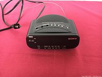 Front view of the Sony clock radio showing the speaker, tuning dial, and Sony branding.