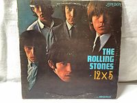 Front cover of The Rolling Stones 12x5 vinyl LP with band photo and album title, showing some wear.