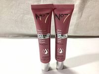 Front view of two pink tubes of No7 Restore & Renew Face & Neck Multi-action Serum showing branding and size details.