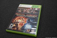 Front cover of Xbox 360 game case with Mortal Kombat Komplete Edition artwork showing characters and rating info.