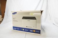 Box for Samsung Xpress printer showing branding, model, and basic specifications including print speed, dpi, and USB connectivity.