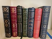 Seven Franklin Library hardcover books displayed upright, showing spine titles and ornate gold details.