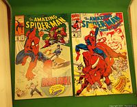 Photo of two Marvel Amazing Spider-Man comic books, issues #5 and #4, laid flat showing their colorful covers.