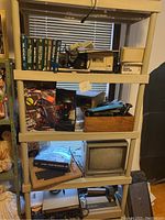 Full shelving unit showing top through bottom shelves loaded with items