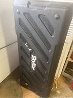 Side view showing large black hard plastic Skyline case with handle