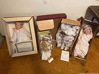 All four dolls displayed in original boxes, showing condition and certificates included