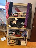 Full image of shelving unit displaying multiple shelves filled with scarves, hats, gloves, and fabric bins