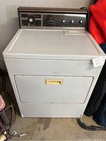 Front exterior view of a white Kenmore electric dryer with control panel on top and front door closed.
