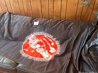 Brown protective cover displaying a logo with railroad equipment and service company text.