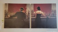 Set of two matching framed canvas prints hung side by side on wall.