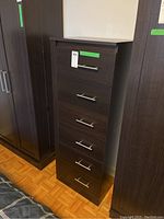 Front view showing dresser's six drawers with metal handles and dark wood finish