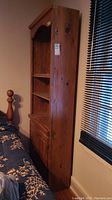 Side angle showing height and depth with natural wood grain and knots visible