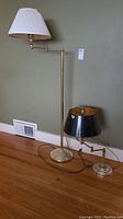 Full view of both lamps showing tall lamp with white shade and shorter with black shade.