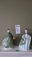 Both Royal Doulton figurines together showing style and size.
