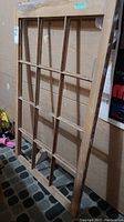 Front and side view of vintage wooden window frame with no glass, showing divided lights structure and wood finish.