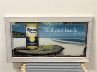 Front view of rectangular wall mirror with Corona Extra beer bottle, lime wedge, and beach background with 'Find your beach.' text.