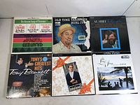 Top view of six vinyl albums including Bing Crosby, Tony Bennett, Burl Ives, Al Hirt and Hawaiian music albums, showing covers and condition.