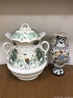 Photo of large urn and smaller vase side by side on shelf.