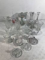 Overview of clear glass items including vases, bowls, and the oil lamp body showing size and arrangement.