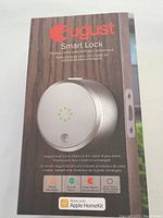 August Smart Lock in original box with branding and features listed on the front.