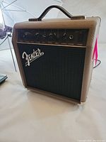 Front and top view of Fender Acoustasonic 15 guitar amplifier showing control panel, input jack, and Fender logo.