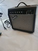 Front view of the Fender Frontman 15G guitar amplifier showing the control panel, input jack, and handle.