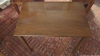 Top view of one mahogany rectangular table showing wood grain and surface wear
