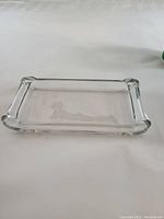Clear rectangular glass dish with gently raised edges and folded corners shown on white background