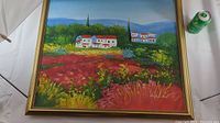 Oil painting showing a landscape with white houses with red roofs, green foliage, and colorful fields in the foreground. Framed in gold.