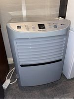 Front view of LG dehumidifier showing control panel and vent grill.