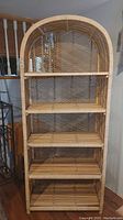 Front view of five-tier shelving unit with arched top and lattice sides
