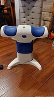 Front view of the Back2Life continuous motion massager showing the blue padded arms and sturdy base.