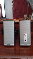 Front view of Bose Companion Series II speakers showing silver color and metallic mesh grill.