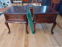 Front view of both mahogany end tables side by side