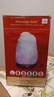 Front of the Mountain Gold Himalayan Salt Crystal Mood Lamp box showing product image and color bulb options