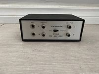 Front view showing input/output jacks and brand/model text on faceplate.