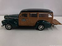 Side view of the 1940 Ford Woody Wagon model showing green body and wood panel details