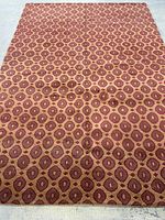 Full view of carpet laid flat, showing overall circular motif pattern
