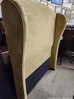 Side view of headboard showing wing back shape and upholstery detail.