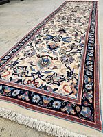 Full view of runner laid out on concrete showing overall design, color and fringed ends