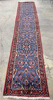 Full view of runner rug laid out on concrete floor