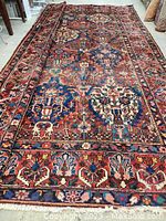 Full view of carpet laid flat showing overall floral pattern and color palette