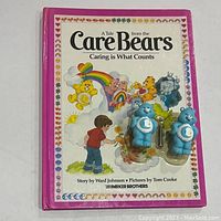 Front cover of the 1983 Care Bears book showing title, artwork with multiple Care Bears, and child figure