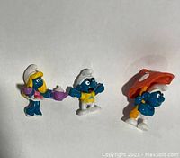Three vintage Smurfs PVC figures, front view showing features and accessories