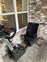 Side view of NordicTrack stationary bike showing mesh seat and pedal crank area